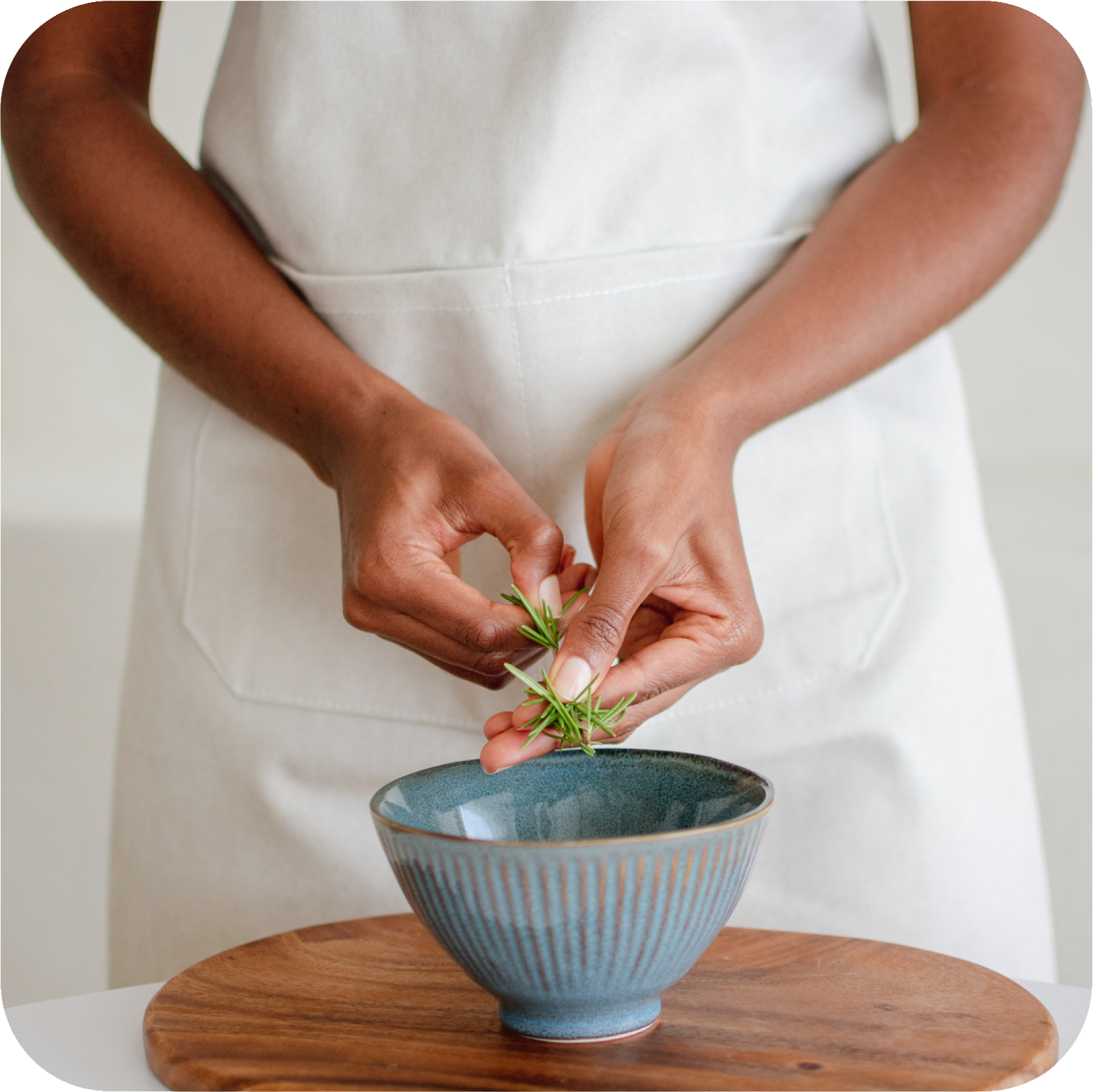 Morning herbal tea routine with fresh herbs being prepared in a ceramic bowl, creating a simple and mindful start to the day.
