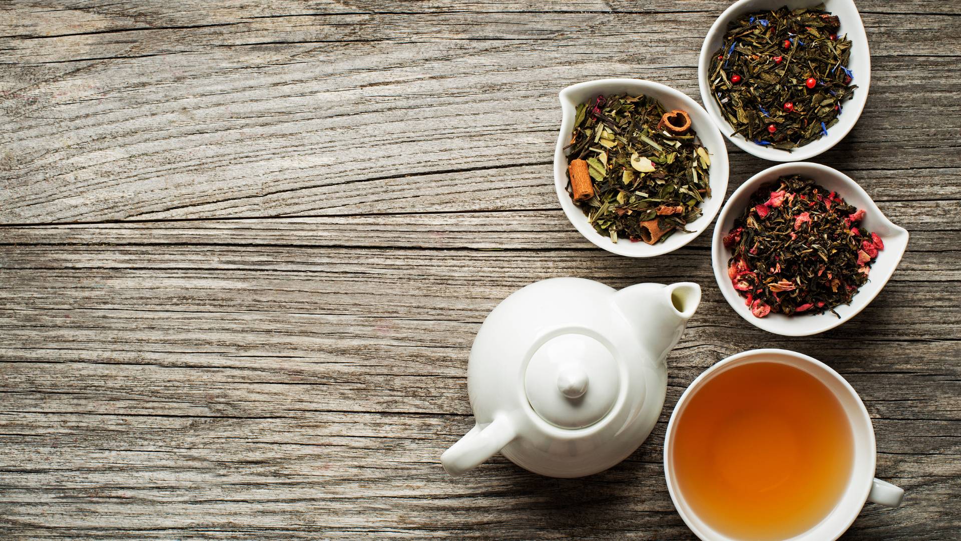 Herbal tea setup with dried herbs on wooden surface, natural herbal tea to support kidney health