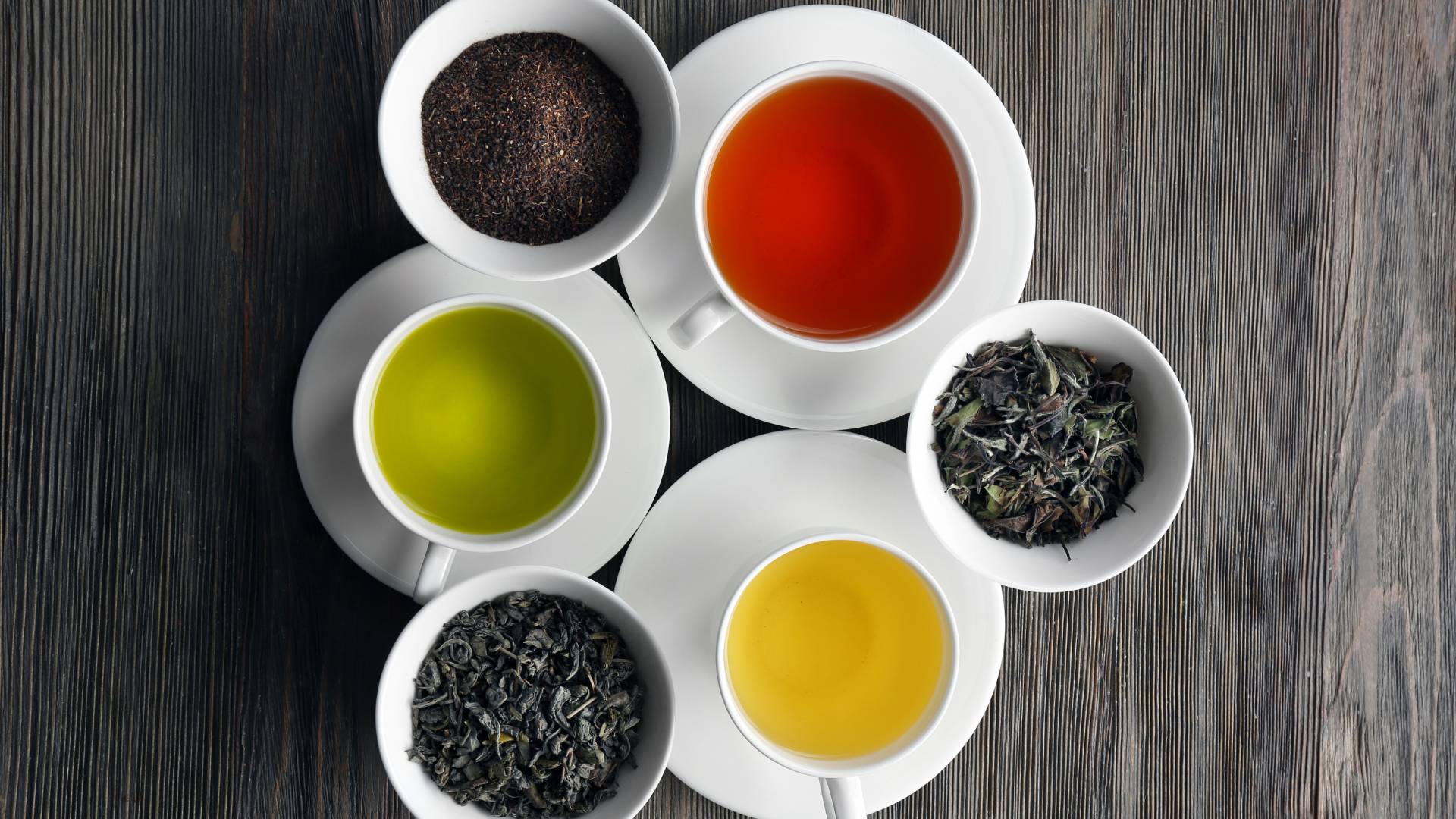 Selection of herbal teas and loose leaf blends in cups and bowls, gentle herbal tea for liver care support