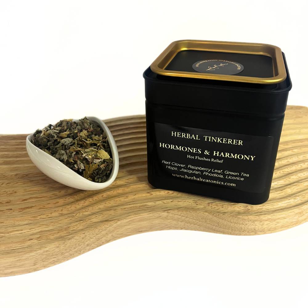 Herbal tea blend tin with loose herbs on wooden board, natural herbal tea for hormonal balance support