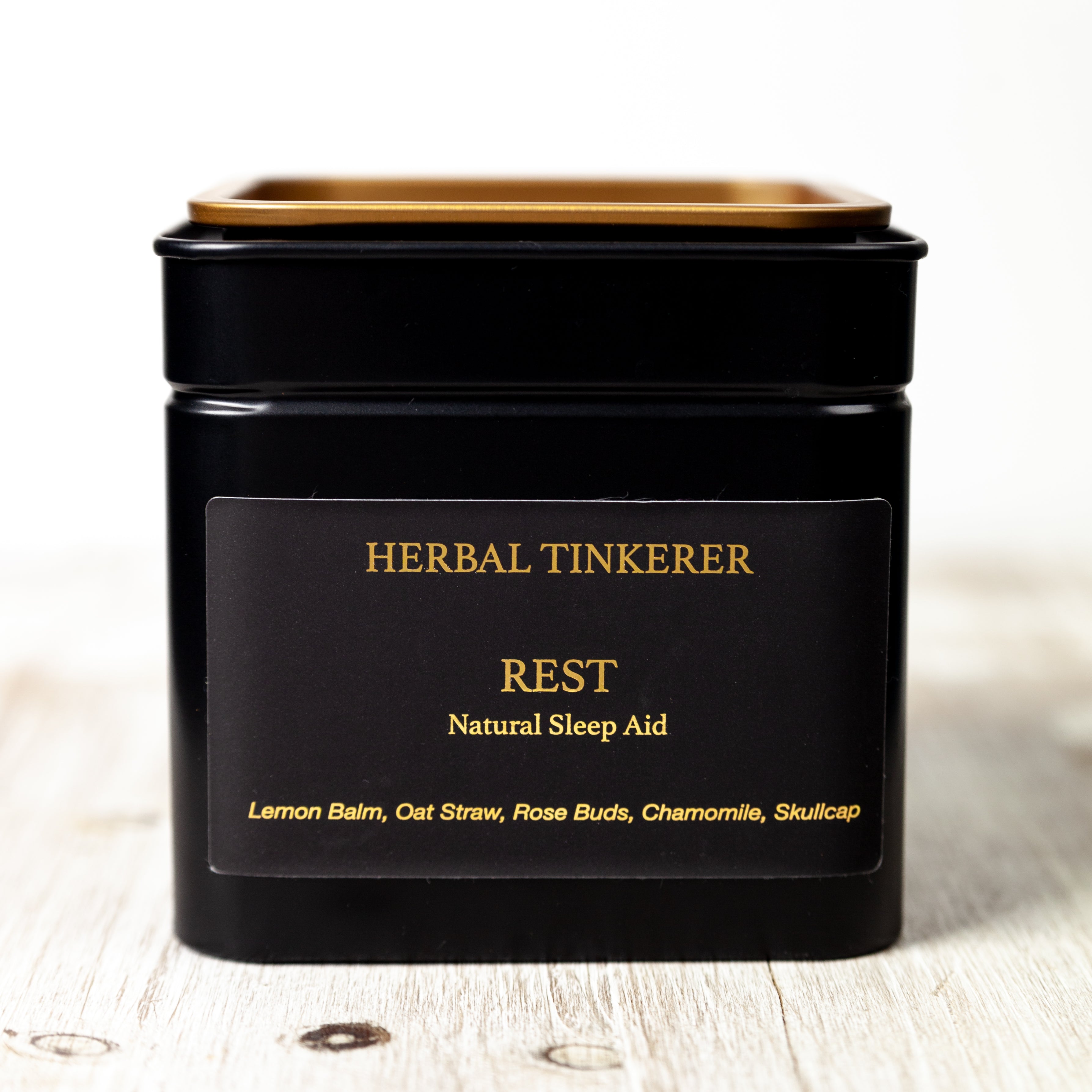 Herbal tea blend packaging with calming herbs on wooden surface, soothing herbal tea for insomnia support
