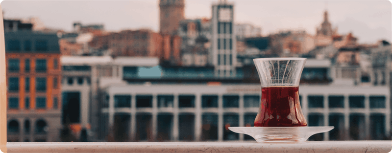 Herbal tea for busy minds enjoyed with a peaceful city view, creating a quiet moment to slow down and unwind.