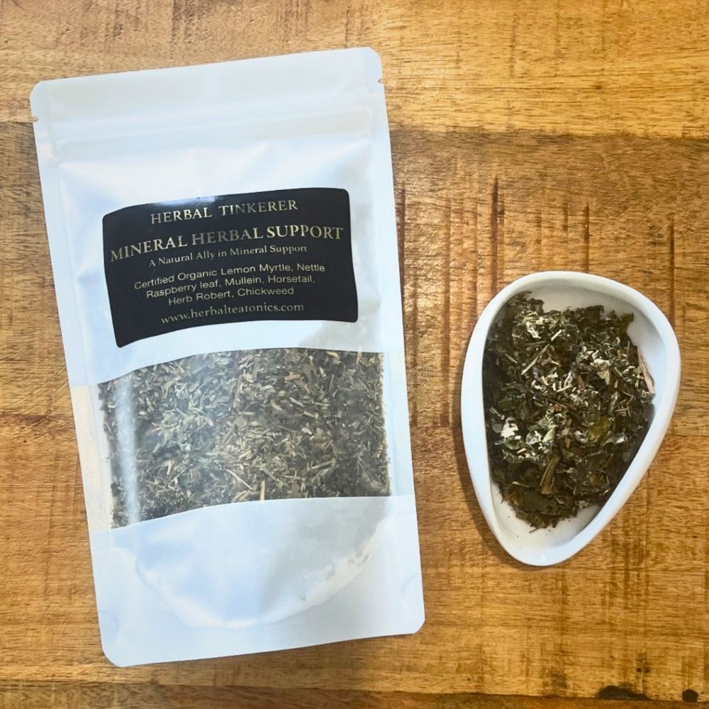 Herbal tisane package labeled 'Herbal Tinkerer' on a wooden surface