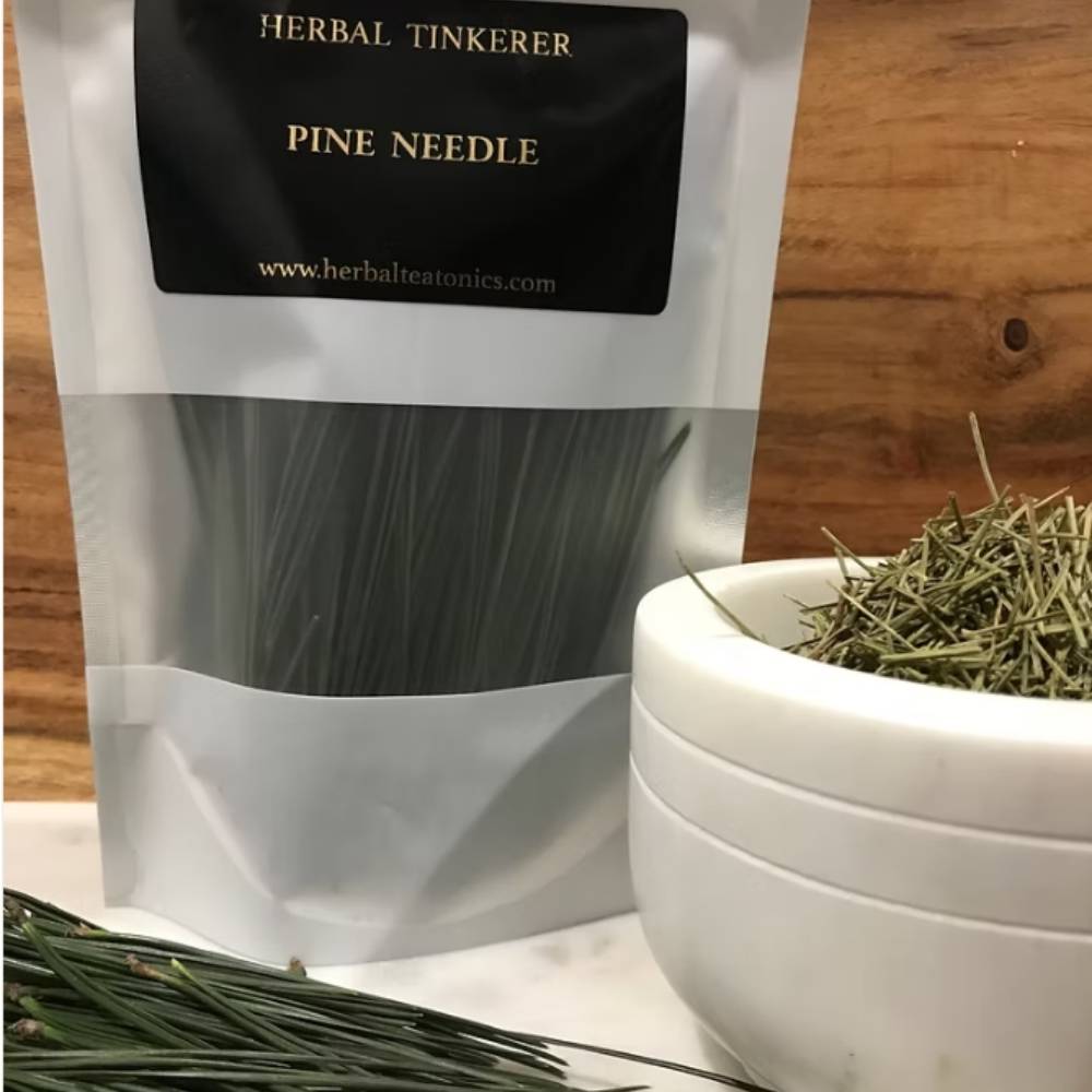 Herbal tinkerer pine needle packaging with a bowl of dried needles on a wooden surface.